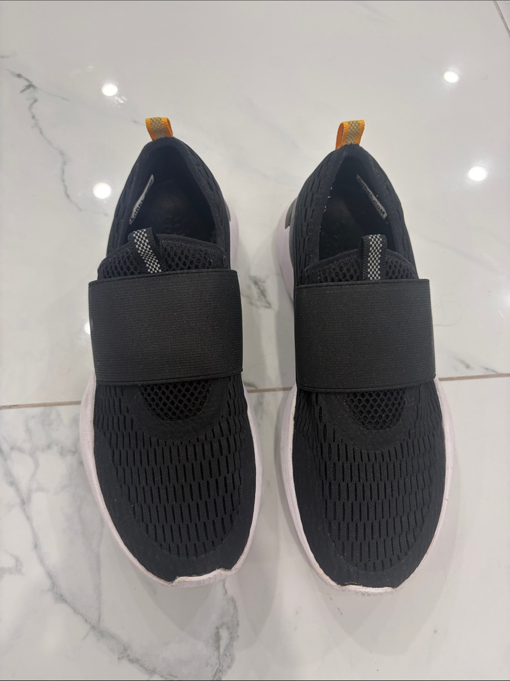Sorel Black Slip-On Women's Sneakers with White Sole and Orange Pull Tab